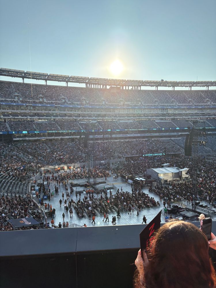 Photograph of MetLife Stadium in New Jersey under bright sunlight while waiting for a concert to start. 