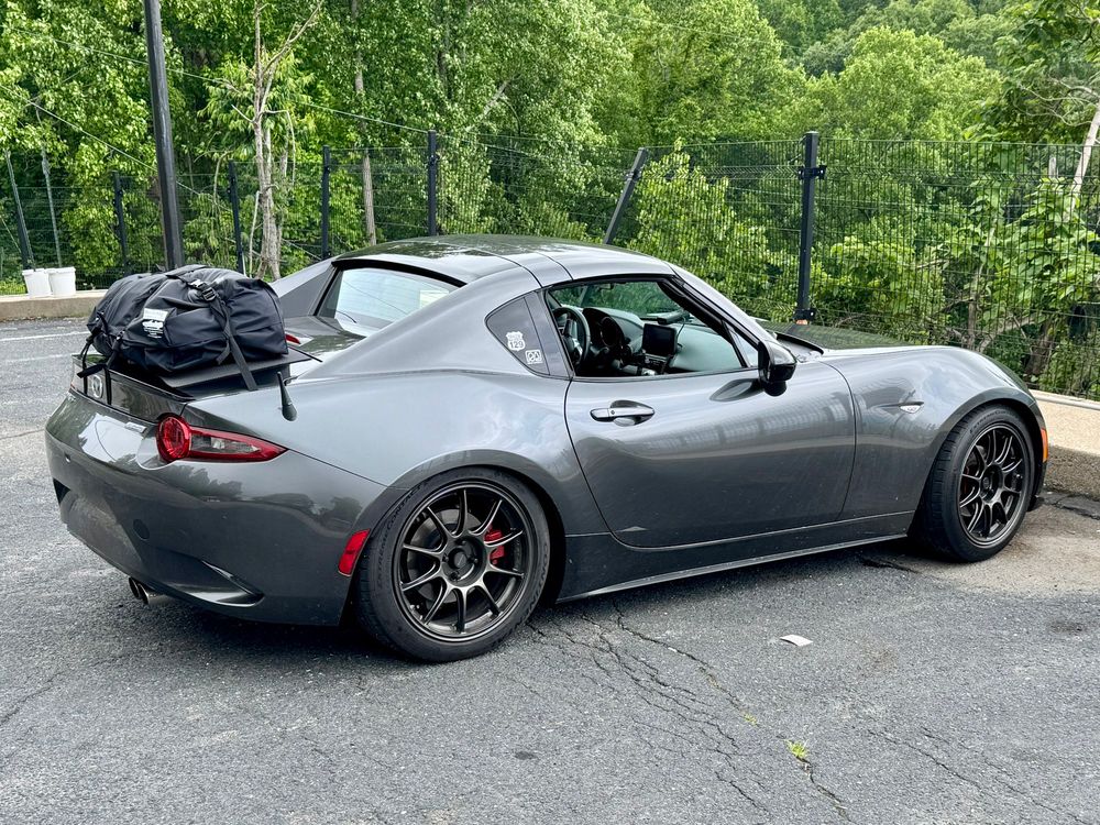Grey ND2 Miata RF with a Boot Bag strapped to the trunk