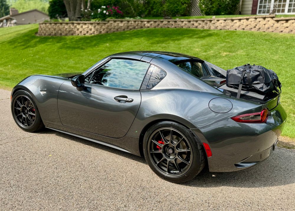 Grey ND2 Miata RF with a Boot Bag strapped to the trunk