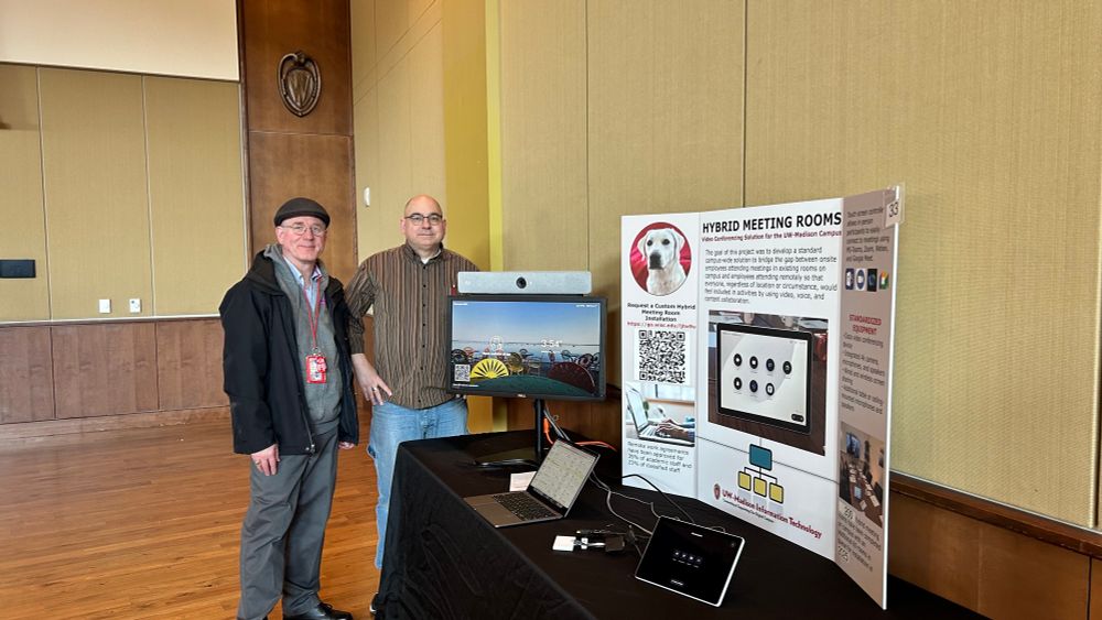  Bill Tishler and Brad Graham standing by their poster at the 2025 Showcase event on the University of Wisconsin - Madison campus. 