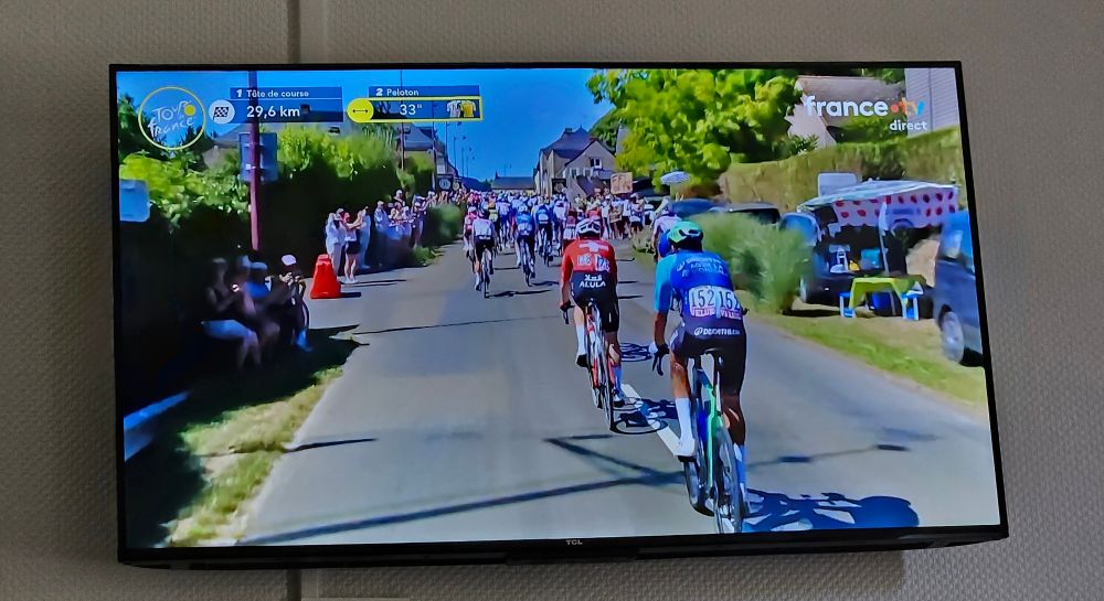 A tv in a French hotel shows riders in the the Tour de France.