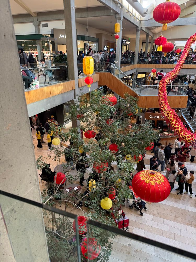 Red lantern and dragon decorations at a large Lunar New Year celebration.