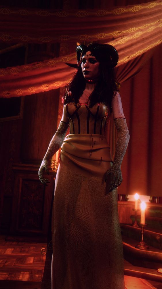 Deeva standing in a dress