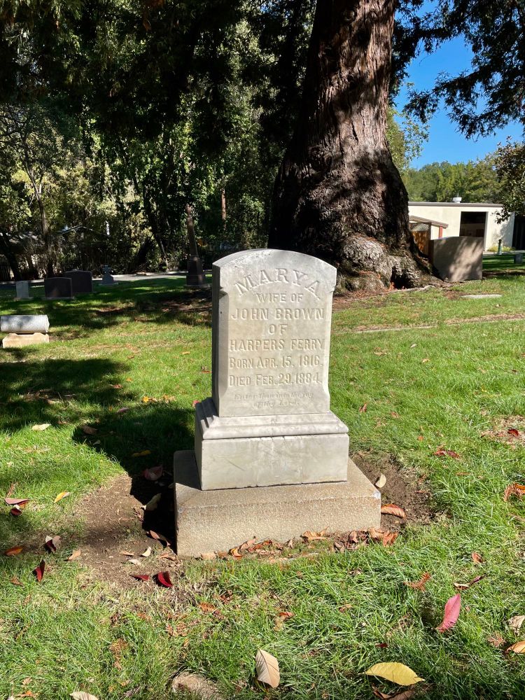 A modest sized white marble headstone that says “Mary A. Wife Of John Brown of Harpers Ferry, Born Apr. 15, 1816. Died Feb. 29, 1884. Enter thou into the joy of thy Lord”