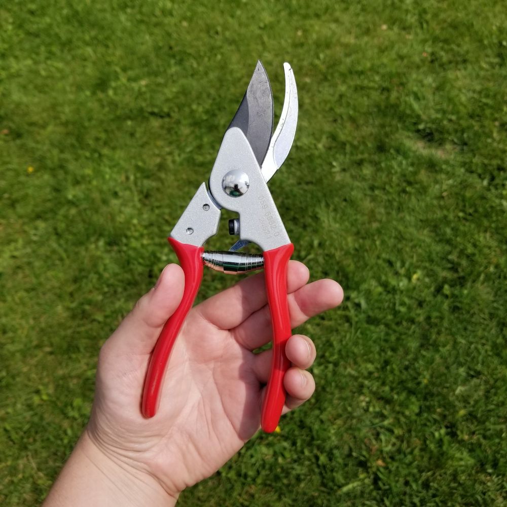 Small pruning shears with red handles that look suspiciously like the ones carried by Narvel Roth