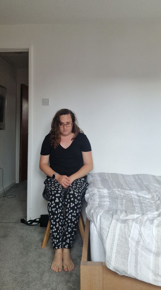 Me sat on a chair at the end of a bed