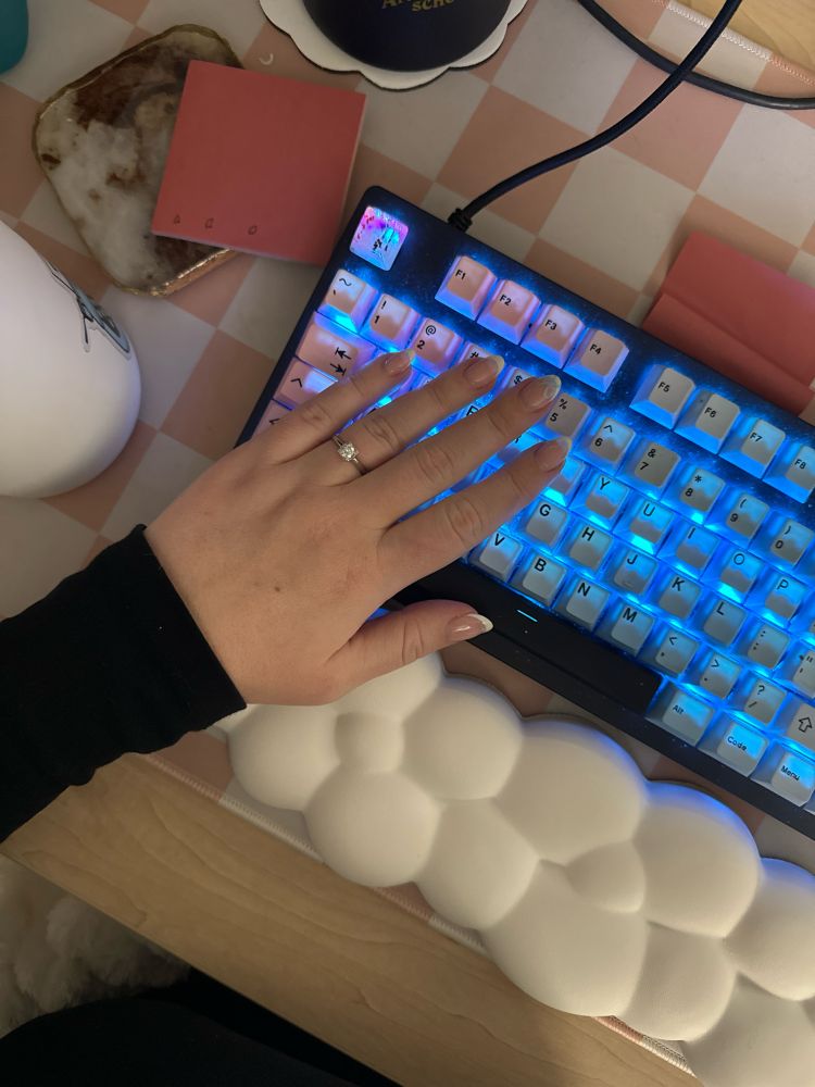 hand with engagement ring over light up computer keyboard 