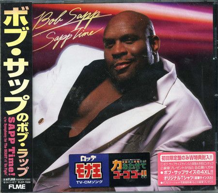 The cover of Bob Sapp's "Sapp Time" single. Bob looking sultry as fuck in a white suit with black shirt unbuttoned to his sternum, with a come hither look on his face. An obi strip on the right shows the title in Japanese.