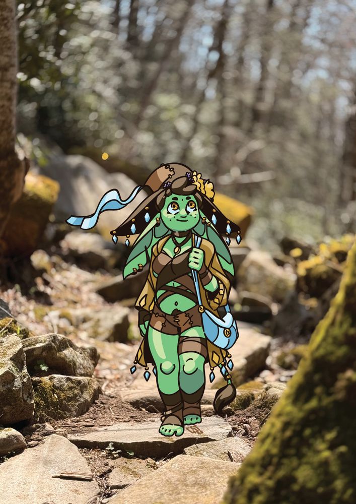 a photo of a rock path in a forest, overlaid with a drawing of a small green goblin with big ears and a tail, in earth-tone clothing with little blue jewels dangling from her hat and coat. She is walking across the rocks, looking upwards wistfully with a slight smile.