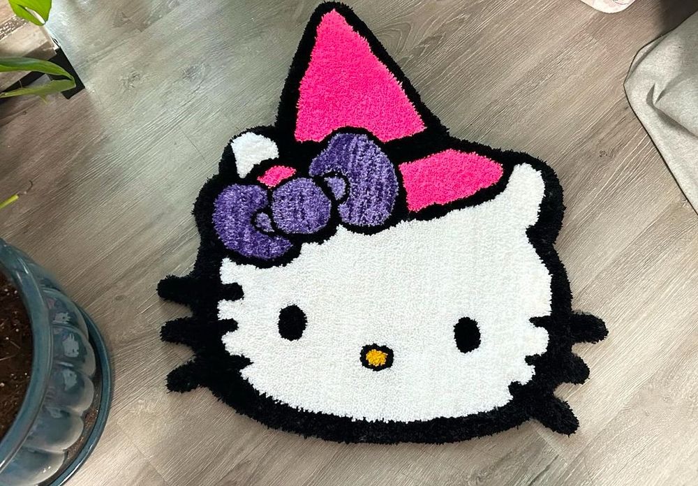 hello kitty with a pink witch had on her head hand tufted rug 