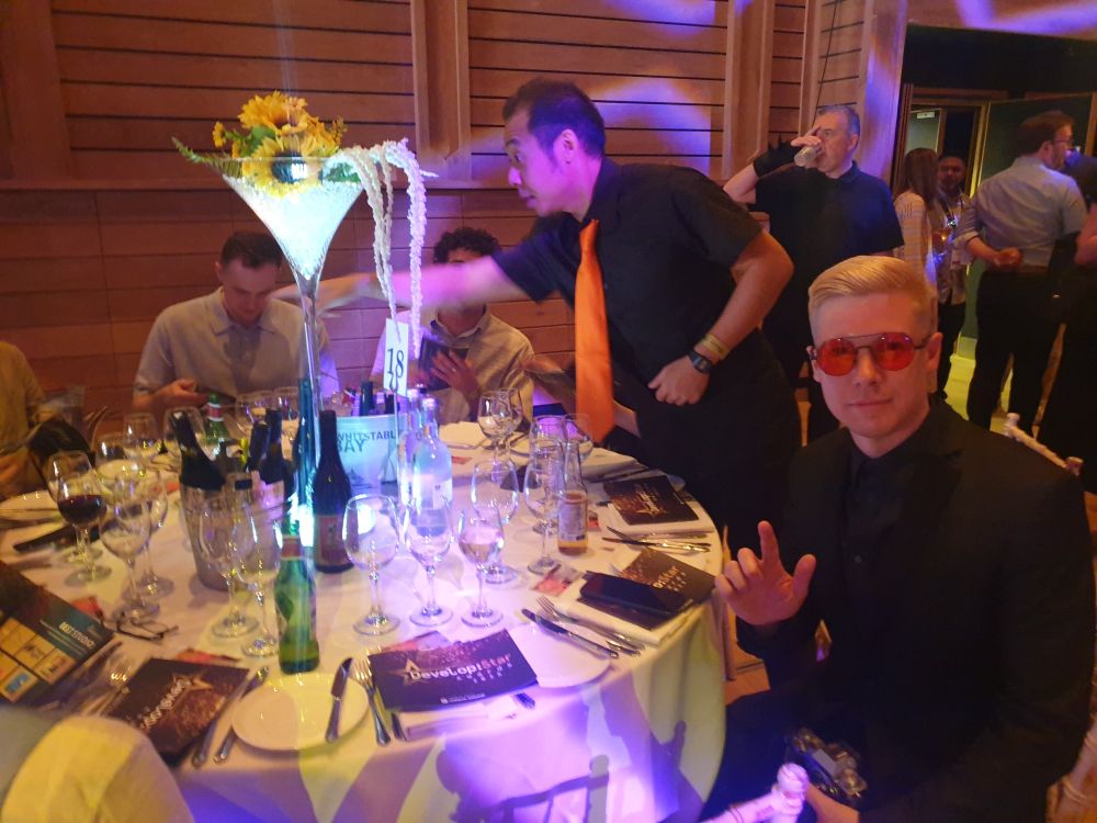photo of a fancy dinner table and guests