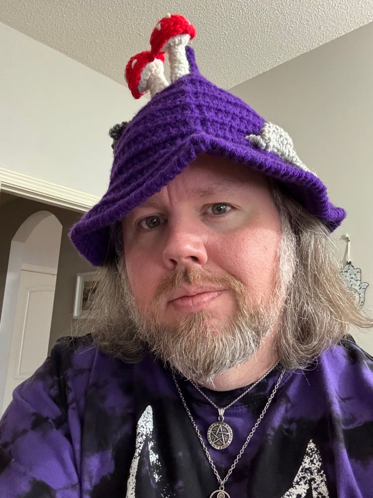 Me in my purple witch hat and purple triple moon t-shirt. Wearing my pentacle necklace and my Morrigan necklace. 