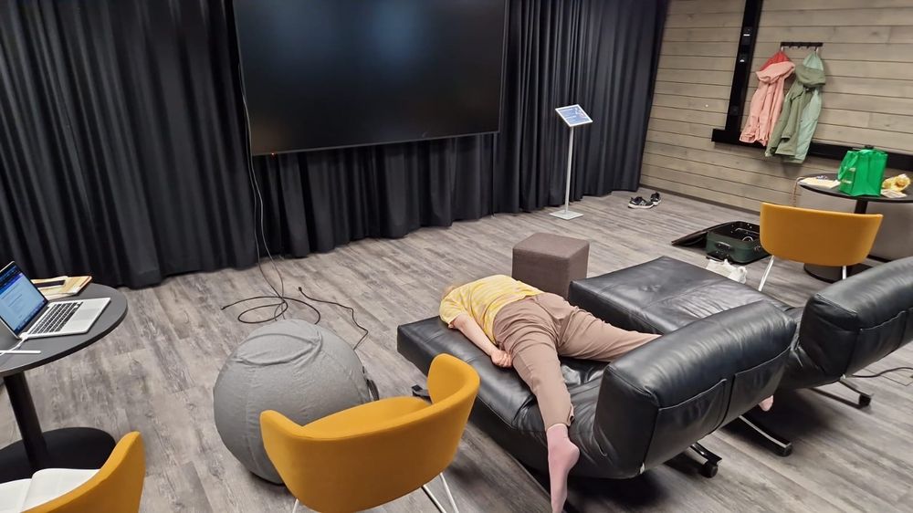 person laying prone on a lounging chair 