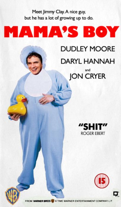 A VHS cover for a fictional film called Mama's Boy. Dudley Moore is dressed in a giant romper costume and holding a rubber duck. The tagline is "Meet Jimmy Clay. A nice guy, but he has a lot of growing up to do". The listed cast is Dudley Moore, Daryl Hannah and Jon Cryer. It features a review reading: "Shit - Roger Ebert". It's all a bit silly.