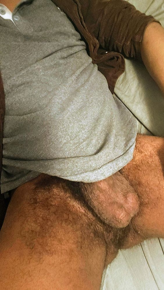 Aaron hiding his cock in his shirt. His balls are exposed. 