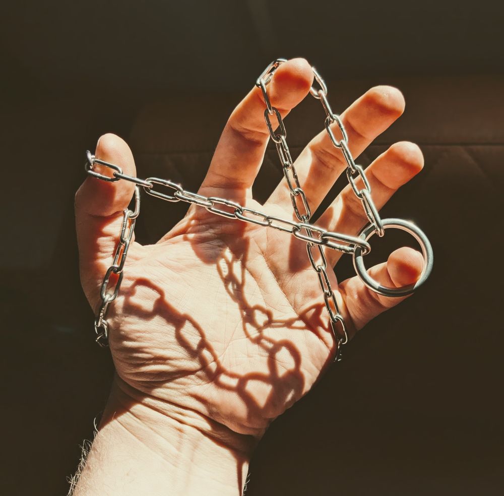 Chain day collar wrapped around my hand with some dramatic lighting