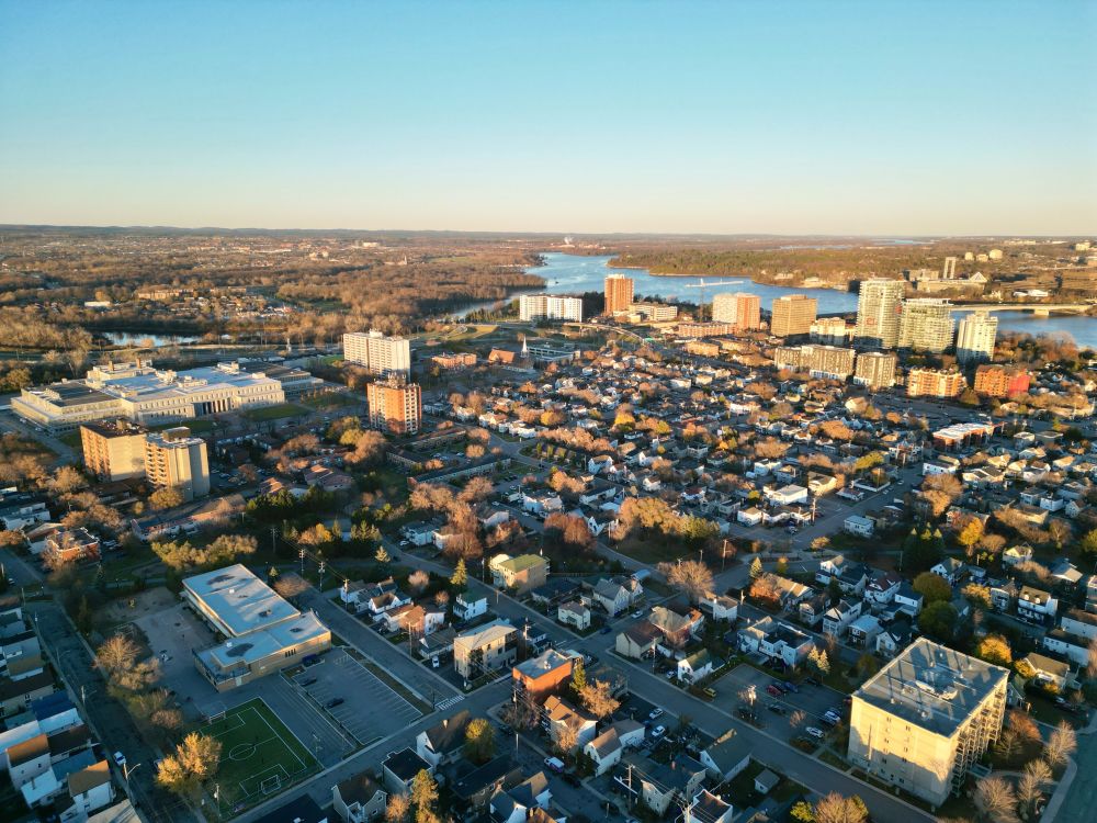 Northeast view of downtown Gatineau with a cluster of taller buildings along the Ottawa river.