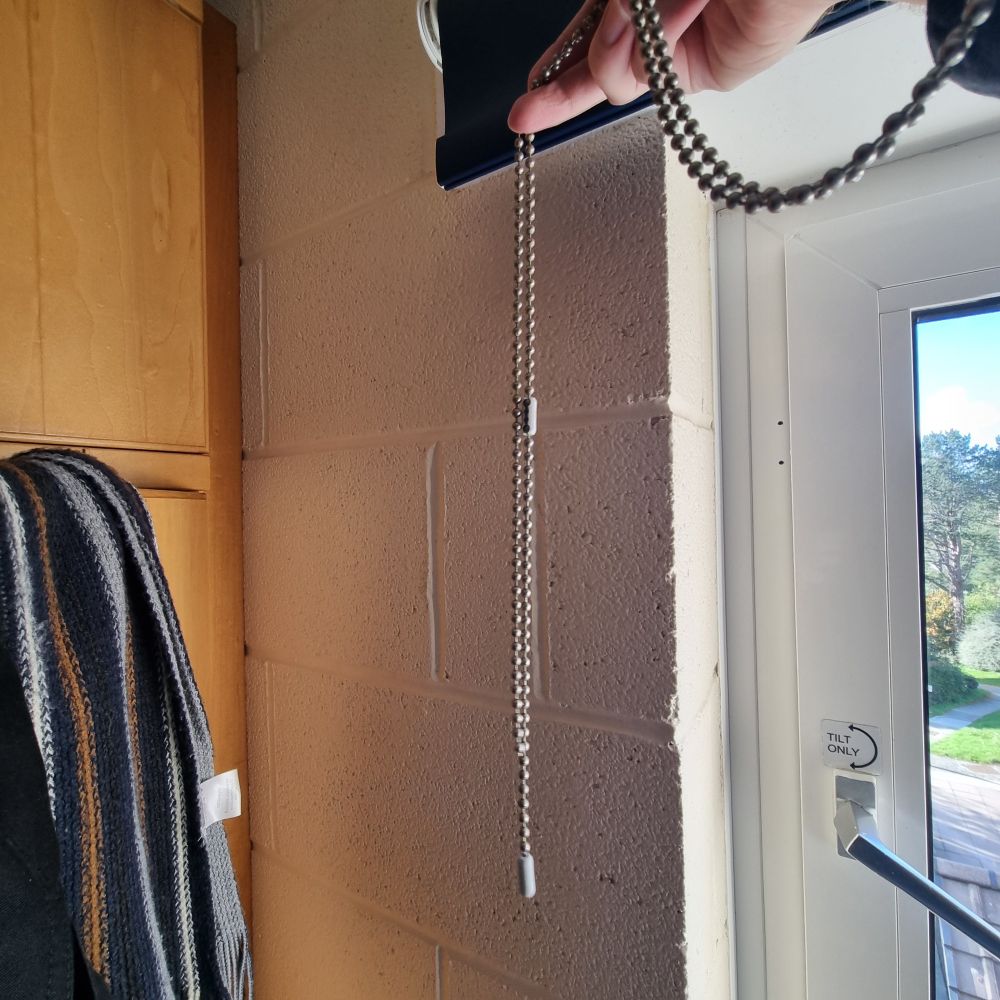 Me holding the chain for the window blinds that I have broken :(