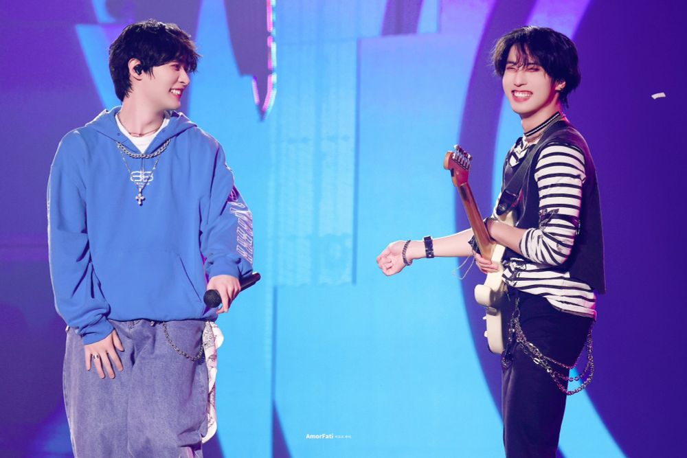 stray kids lee know grinning at a similarly grinning han during lee know cheer up time which i miss like a limb every single day of my life