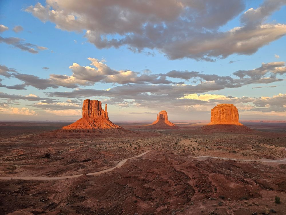 view of Monument Valley with the shadow of one of the mitten buttes on the other mitten butte