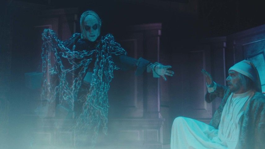 Jacob Marley in chains speaking to Scrooge.