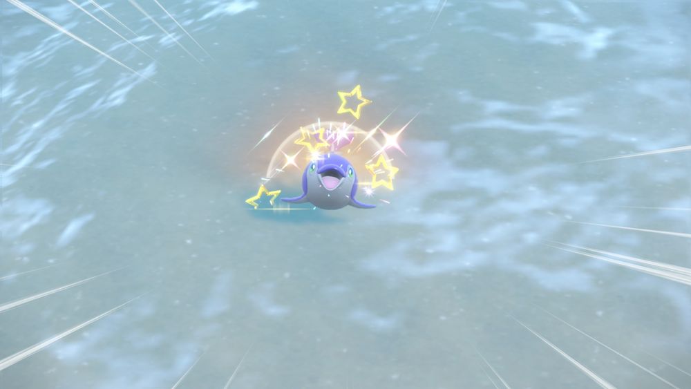 Screenshot of encountering a shiny Finizen dolphin Pokémon with golden star sparkles surrounding it, from the game Pokémon Scarlet. (Regular Finizen is blue, while the alternate colored "shiny" variant is purple instead.)