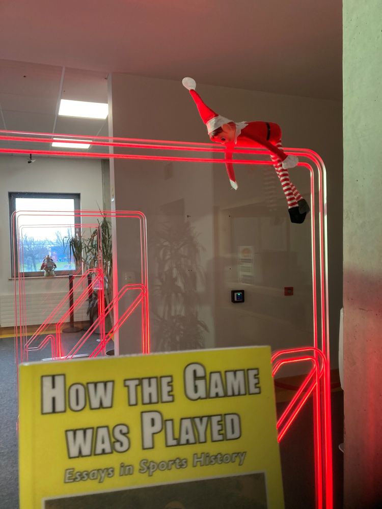 Picture of ATU Library Galway's Elf on the shelf setting of the security alarm on our gates cause he didn't check the book out! 