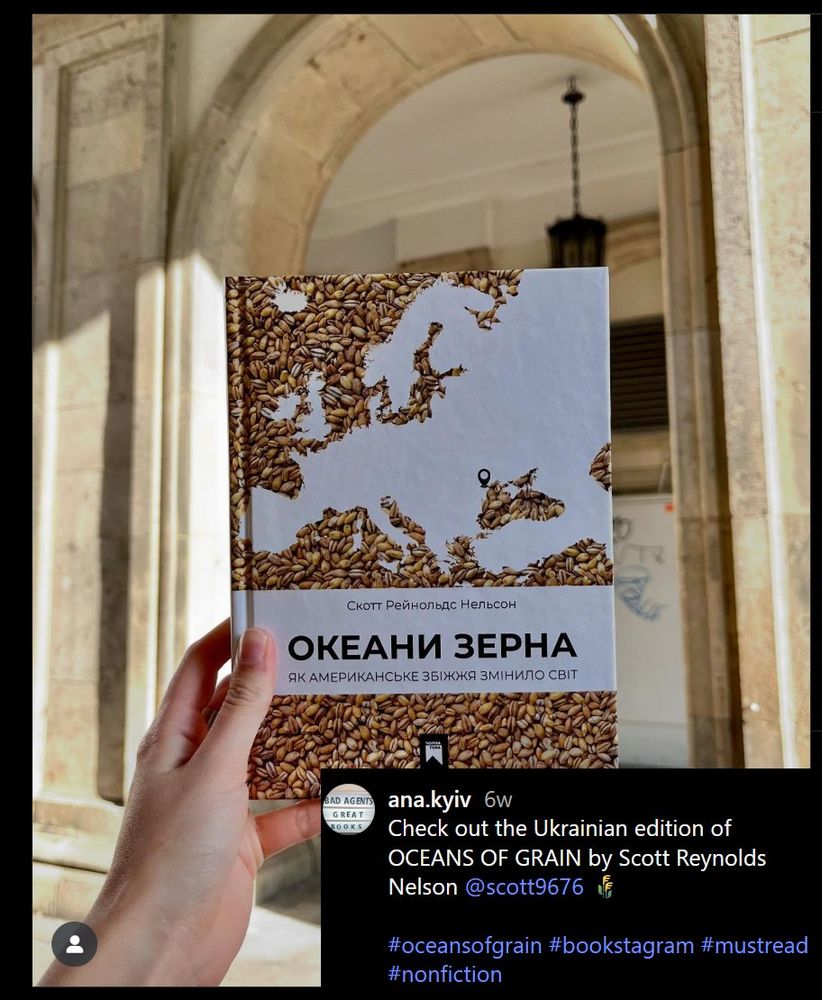An instagram post of a person holding a copy of the Ukrainian translation of Scott Reynolds Nelson's book, Oceans of Grain in front of a marble archway