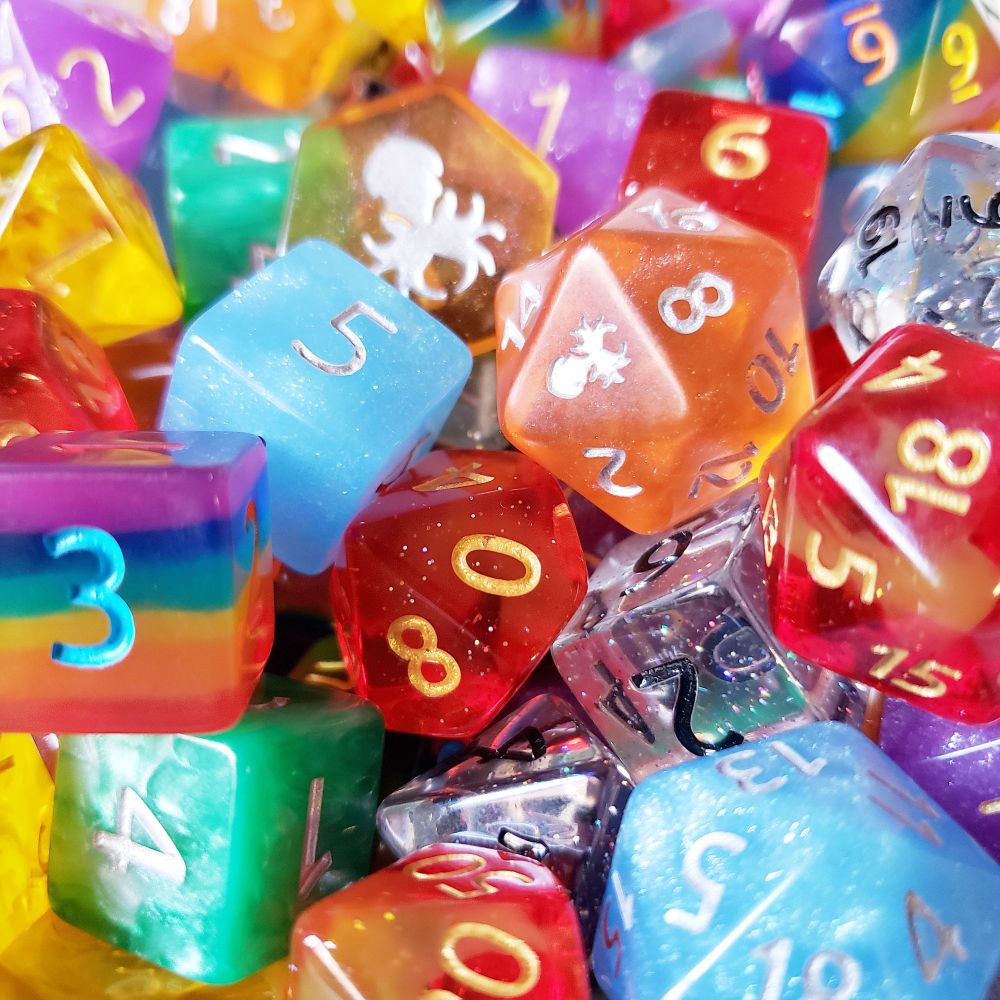 A pile of multicolored polyhedral dice in the colors of the rainbow