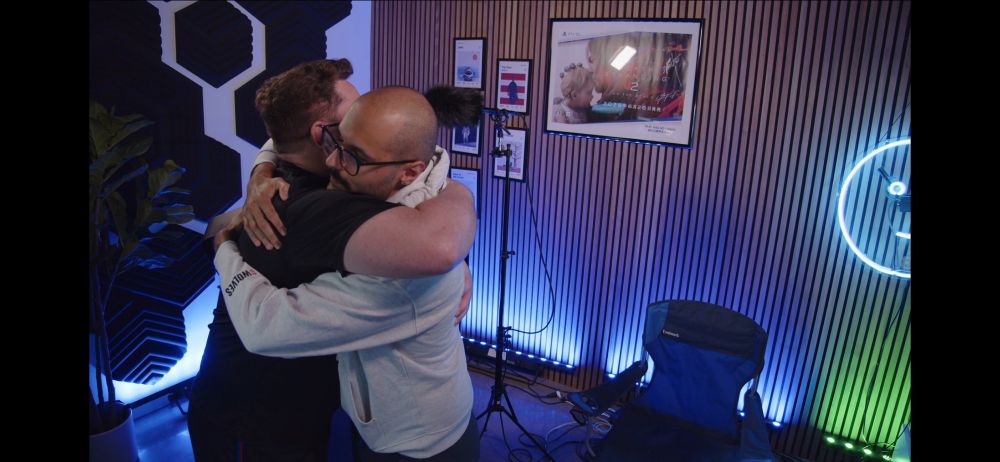 Two bros hug after a marathon Twitch stream.