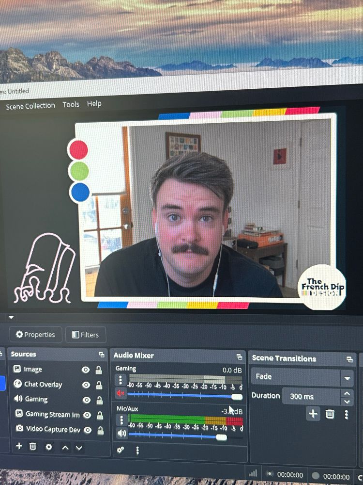 A man looks into the camera on his OBS stream setup! He’s still learning the ropes, be nice to him!