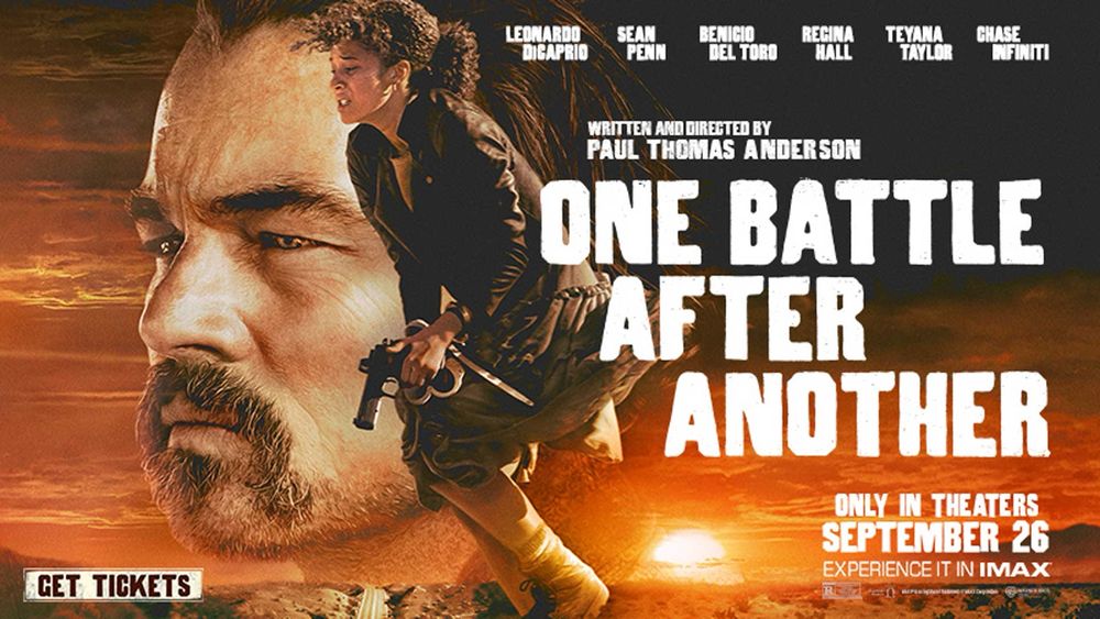 The horizontal movie poster for One Battle After Another. Featuring Leonardo DiCaprio’s MASSIVE face and Chase Infiniti holding a gun with a deep orange sunset on the horizon.