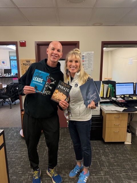 Photo of Dave Burgess with Lisa Reed holding 2 books and a journal.  