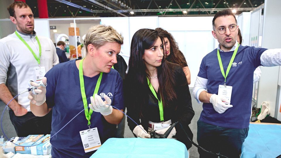 a group of people looking at a device