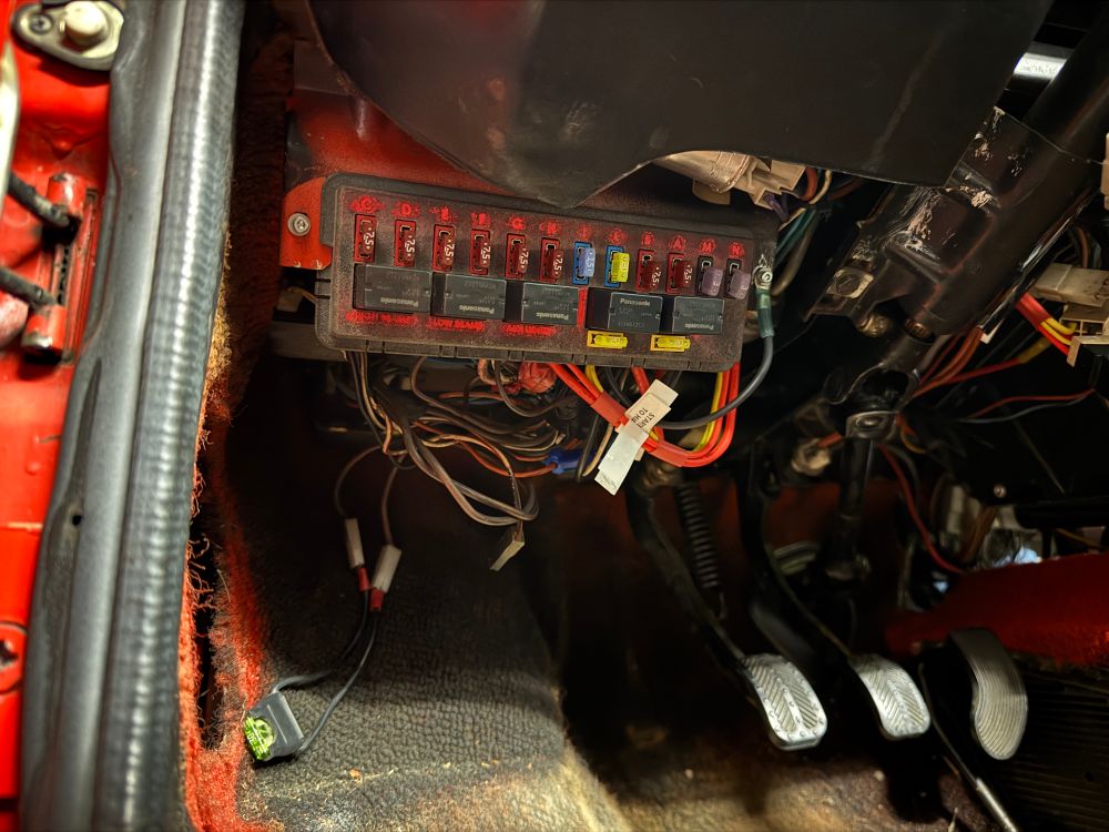 a poorly-lit picture of the new fusebox installed on the driver footwell