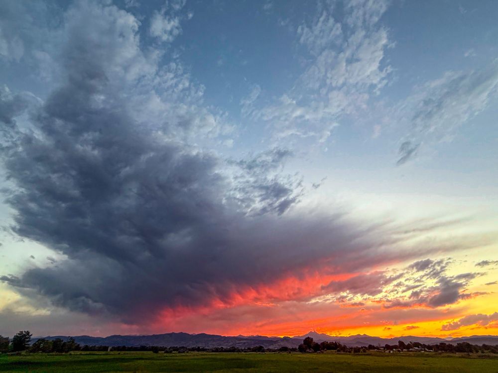 A dramatic Colorado sunset with dark storm clouds sweeping across the sky, glowing with streaks of fiery red, orange, and gold over distant mountains. The scene captures the ever-changing rhythm of the sky, reflecting the beauty of transition and transformation.

Keywords:
nature, outdoors, sky, clouds, sunset, Colorado, photography, inspiration, mindfulness, wellness, well-being, quote, meditation, healing, flow, transformation, seasons, landscape, horizon, mountain, storm, light, beauty, peace, spiritual, poetic, energy