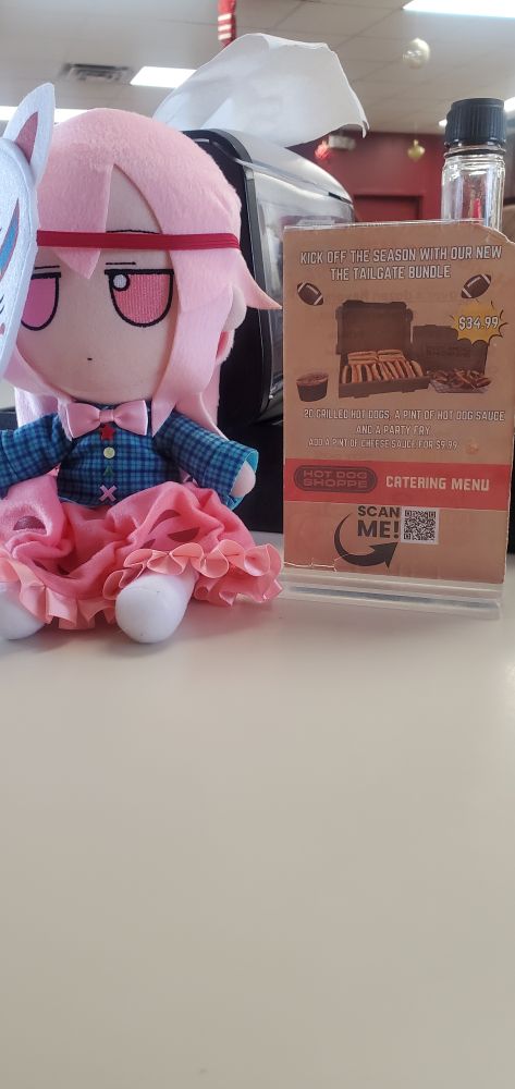 Touhou Project Kokoro fumofumo plushie at a restaurant called the hotdog shoppe. 
