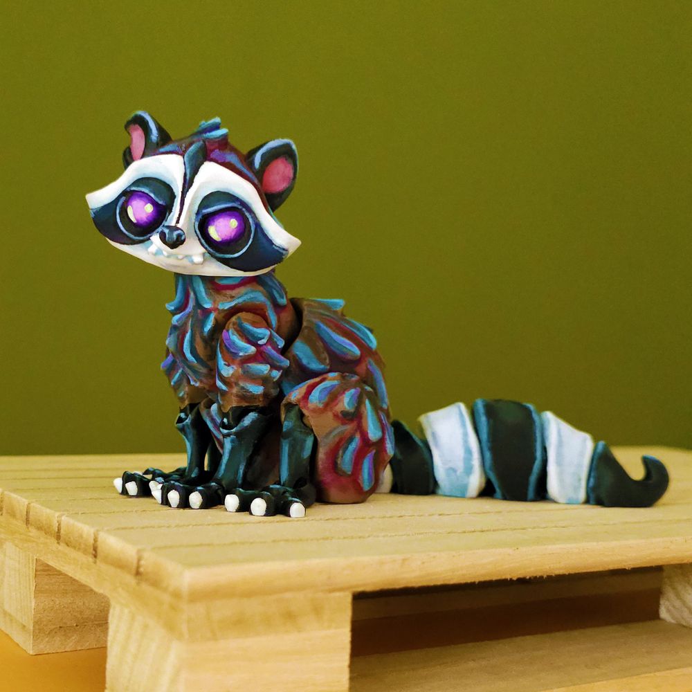 3d printed and handpainted raccoon sitting on a wooden platform, on a green background, sitting, smugly.
