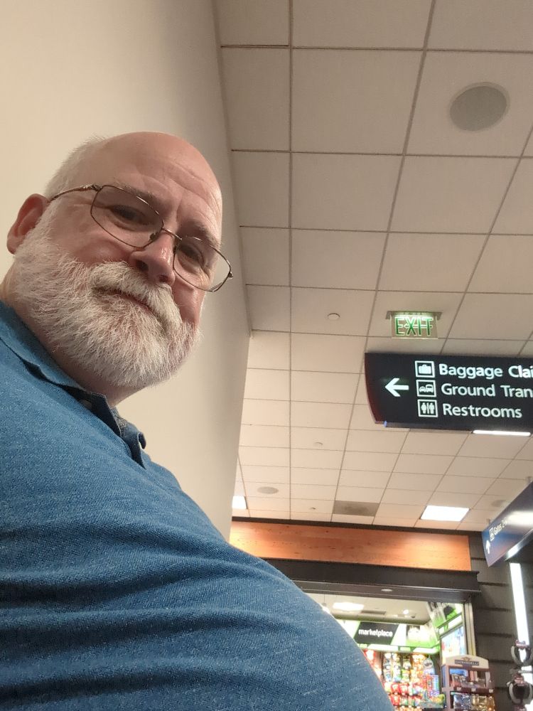 GupDaddy, sitting in an airport, waiting for a flight