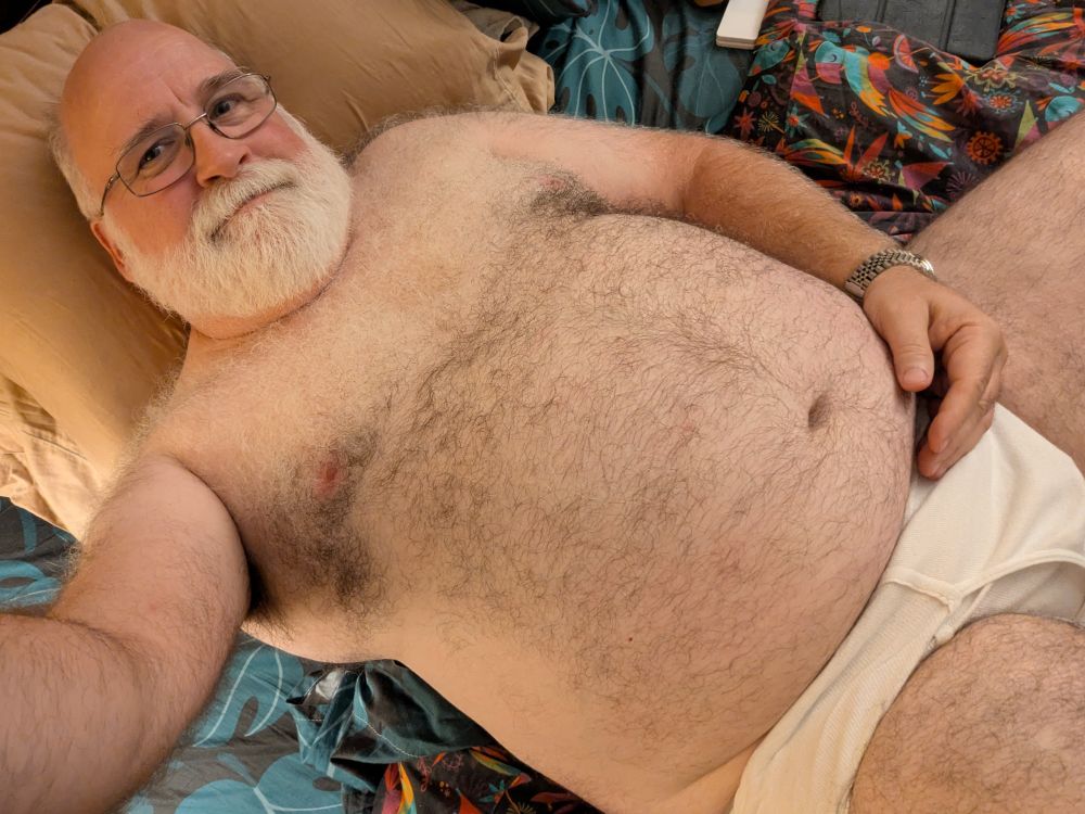 GupDaddy, getting ready for bed in his tighty whities, laying back with a hand under his round belly 