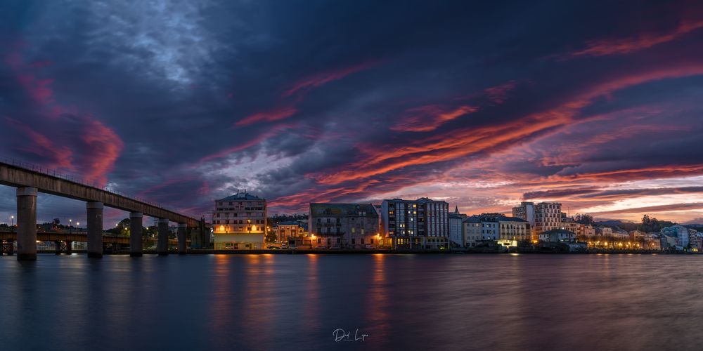 A beautiful sunrise over an Asturian village reflected on the river