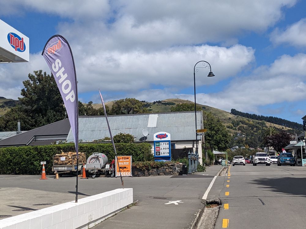 Wind banner on City street under clouds in a blue sky.