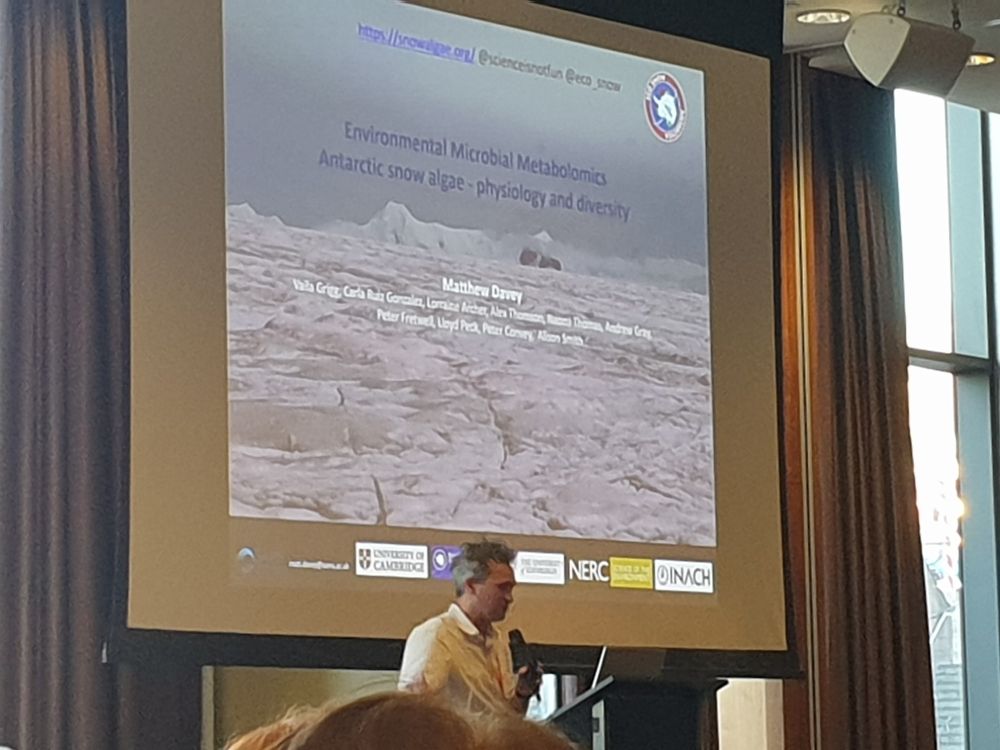 Matthew Davey in front of the title slide of his talk