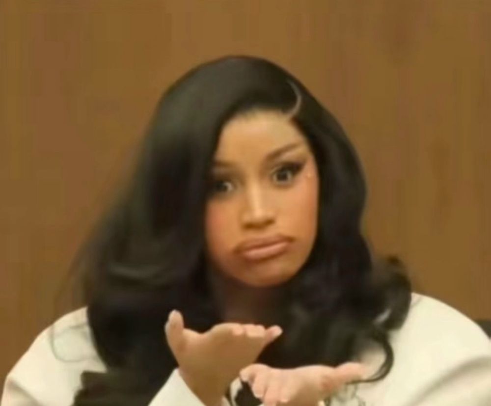 Cardi gesturing on the stand 