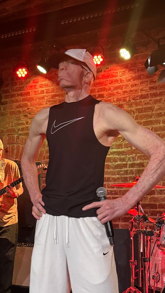 King Yellowman stands on stage preparing to begin 