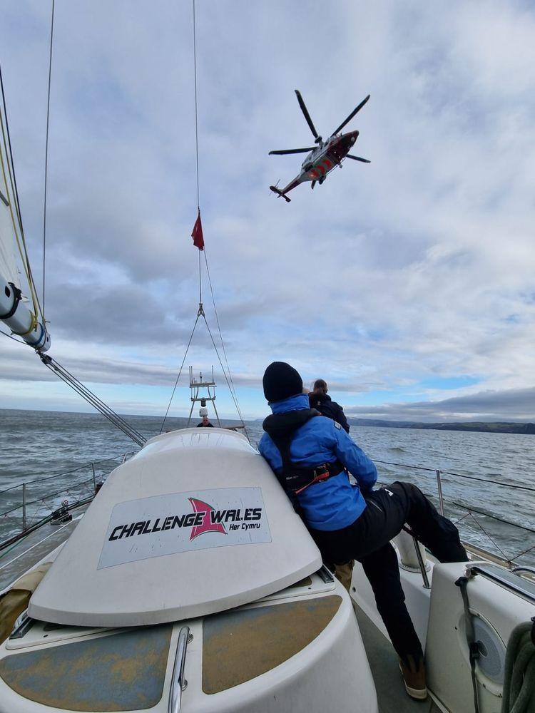 A Coastguard Helicopter is hovering at the back of Challenge Wales ready for a training exercise.