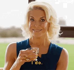 GIF of Hannah Waddingham looking gorgeous as Rebecca Welton saying ‘I do’ as shrugging whilst looking smug 