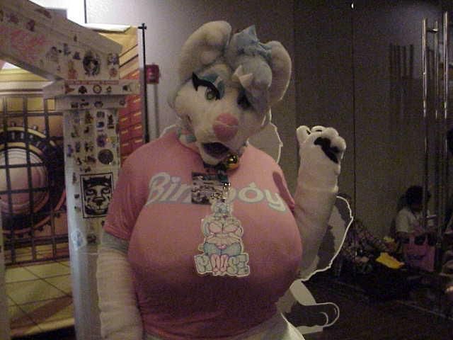 A bustyboy fursuiter flashing a peace sign