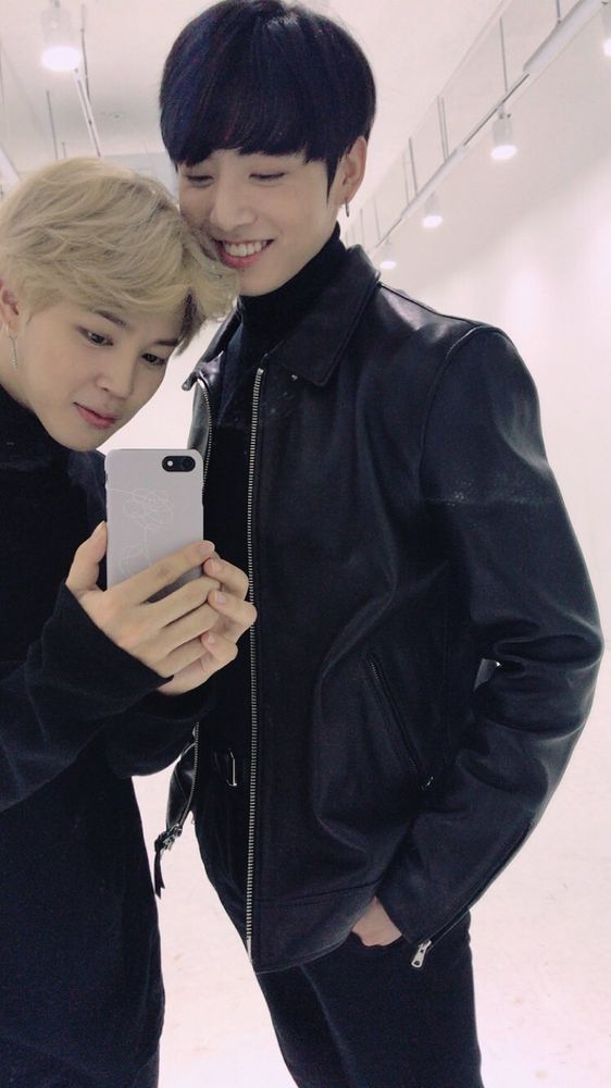 An iconic Jikook selca. They're both wearing all black clothing. Jimin is blonde, he's slightly smirking and holding the phone with both of his little hands while he takes the picture. His phone case is even BTS LYS themed. Jungkook has dark brown hair, he's wearing a turtleneck under his leather jacket, standing with his hands in his pockets a big smile on his face as he looks down at their reflection on the phone screen. 

This photo is from the official bts twitter account from 10.31.17 with the caption
☺️💐
#BTSLoveMyself  #BTS #방탄소년단
#JIMIN
#꾹