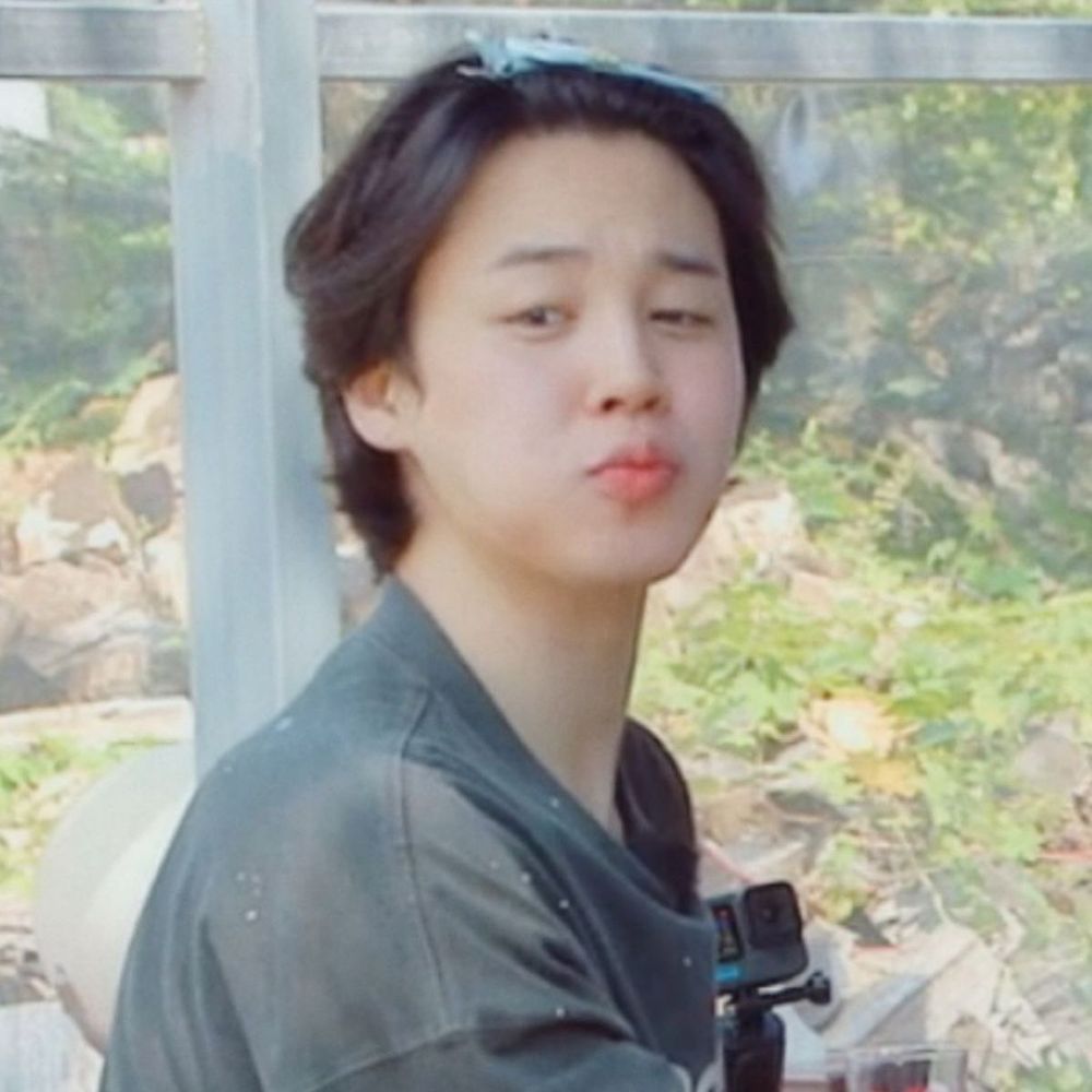 Jimin poking his little beakie out while wearing a cinnamoroll clip in his hair 